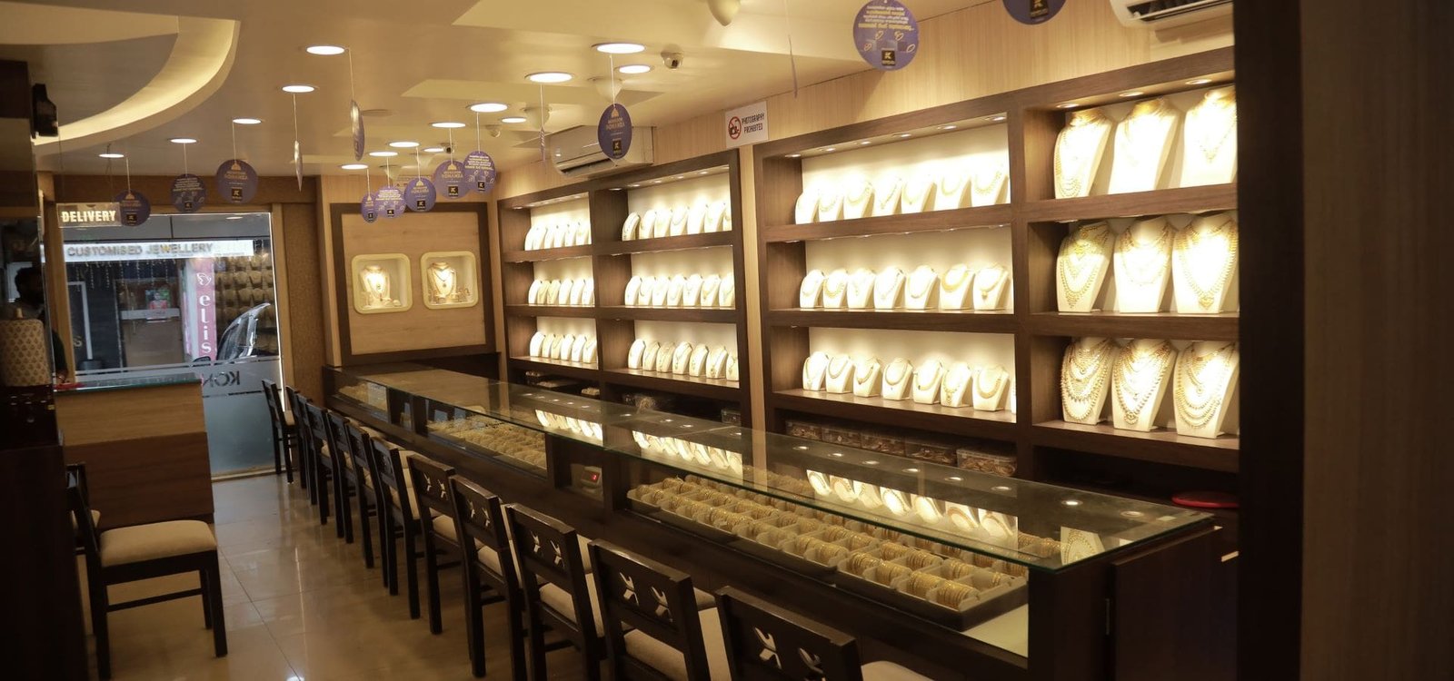 Inside TC Gold showroom — illuminated gold display counters at TC Tower, Thrissur